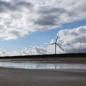 A wind turbine overlooking a beach